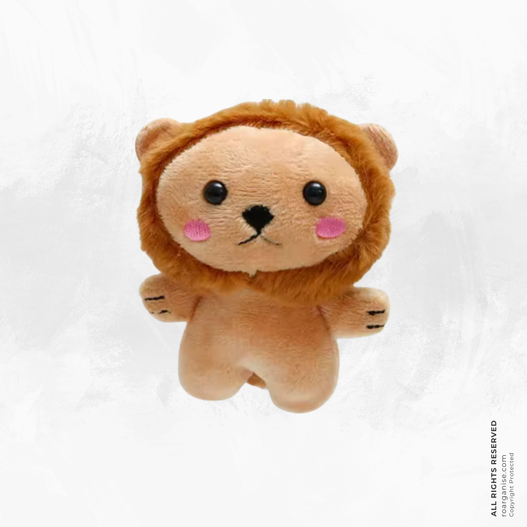 A small plush lion toy with a tan face and body, brown mane, black eyes and nose, and pink cheeks, centered on a light gray background.